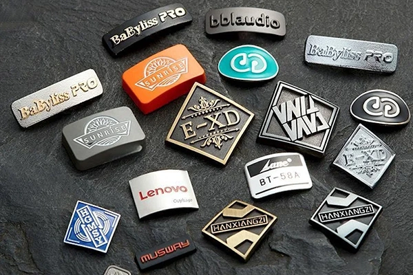 Zinc-alloy-branding-component-applied-to-consumer-products-and-equipment-for-visual-and-tactile-impact