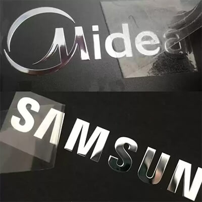 Close-up of ultra-thin nickel metal stickers showcasing custom logo engraving and sleek design for branding applications.