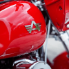 Custom chrome motorcycle emblem mounted on gas tank