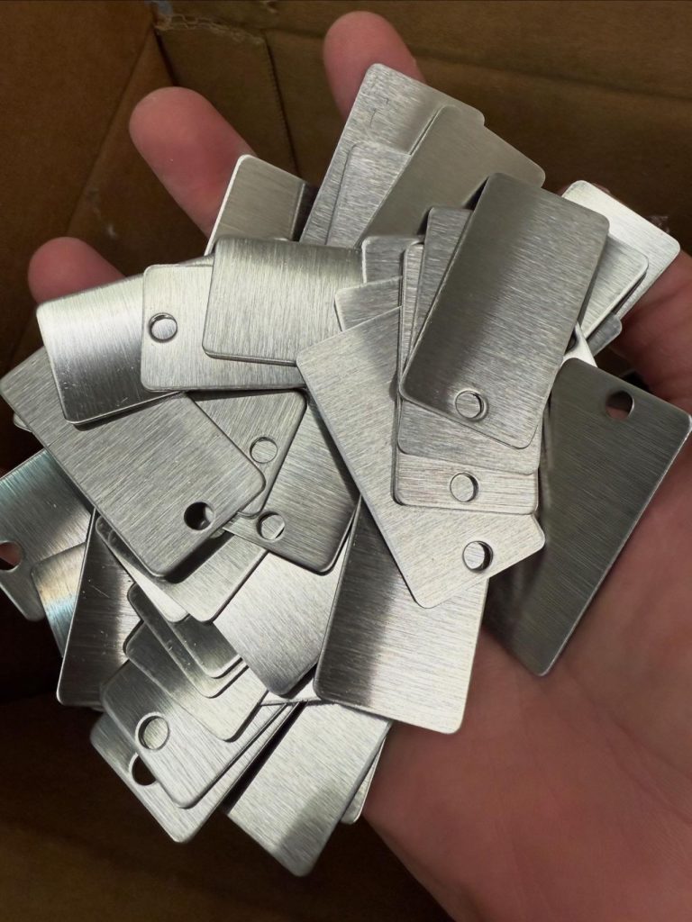 Close-up of corrosion-resistant metal nameplate with protective coating for industrial machinery
