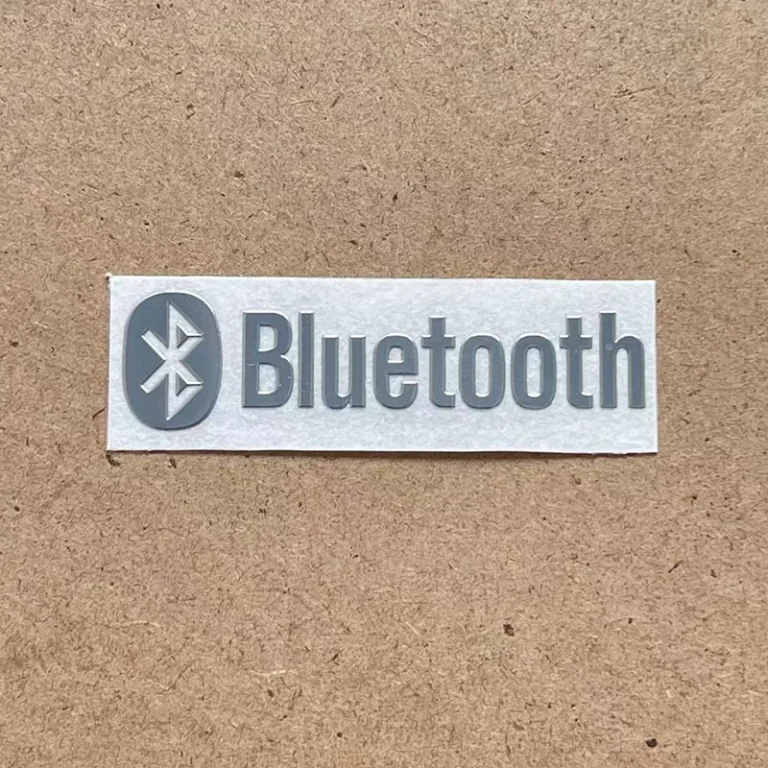 Close-up of metallic emblem with anti-fingerprint plating for Japanese audio brand