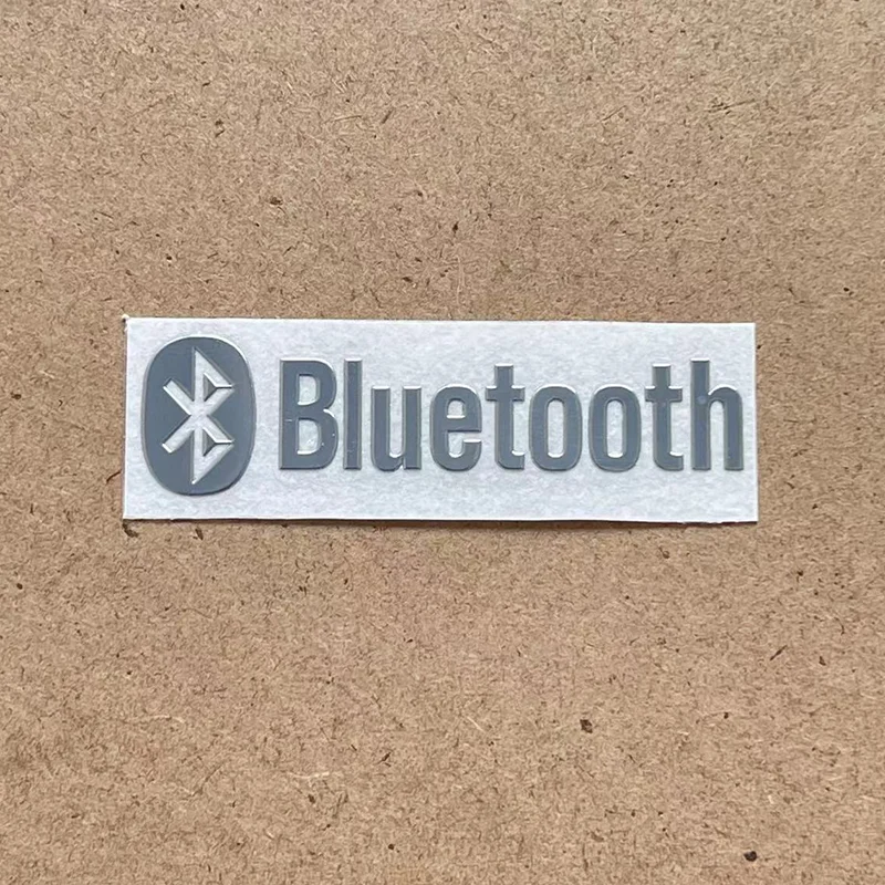 Close-up of metallic emblem with anti-fingerprint plating for Japanese audio brand