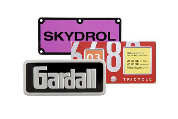 Embossed-metal-nameplates-with-raised-lettering-and-polished-finish