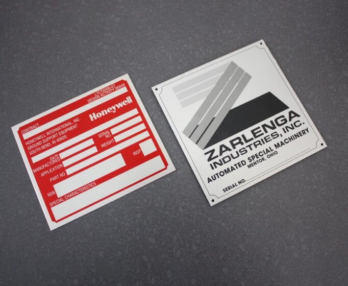 Custom metal equipment labels mounted on machinery housing - Himgo